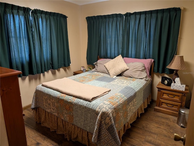 bedroom featuring dark hardwood / wood-style flooring