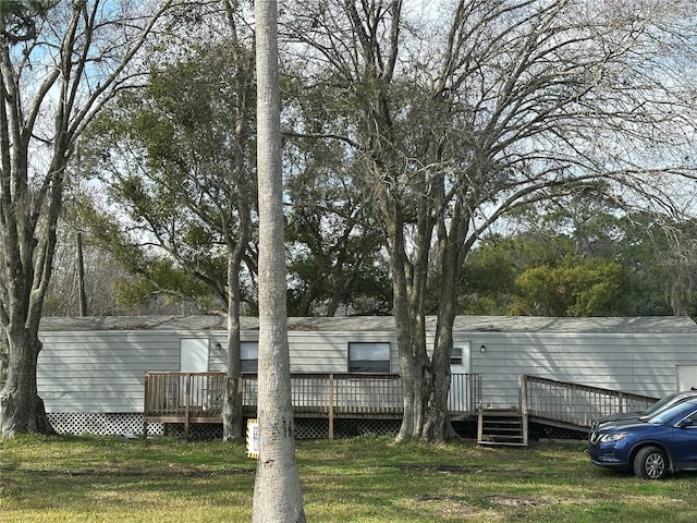 exterior space featuring a deck and a lawn