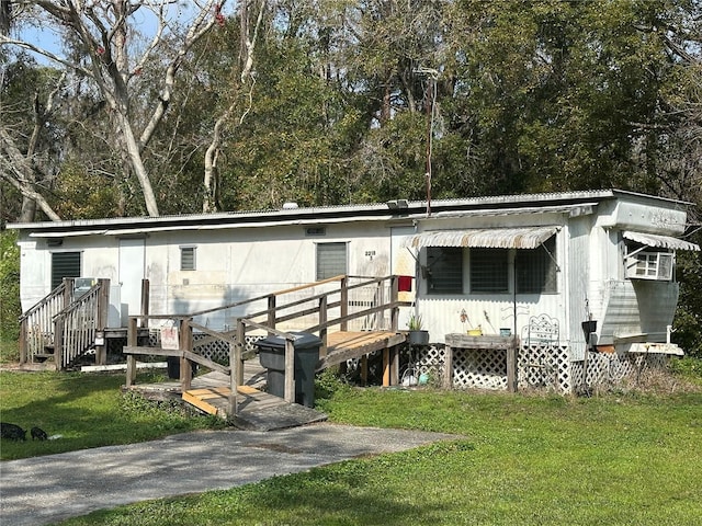 rear view of property featuring a yard