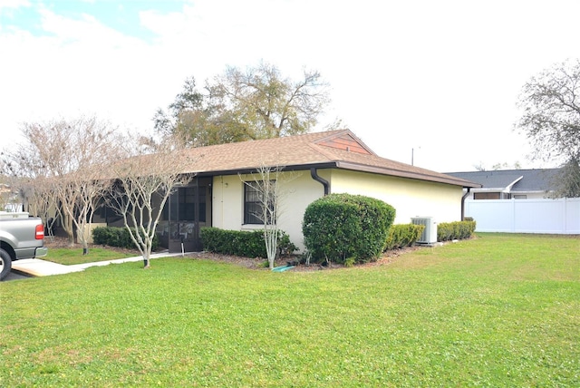 view of home's exterior with central AC unit and a lawn