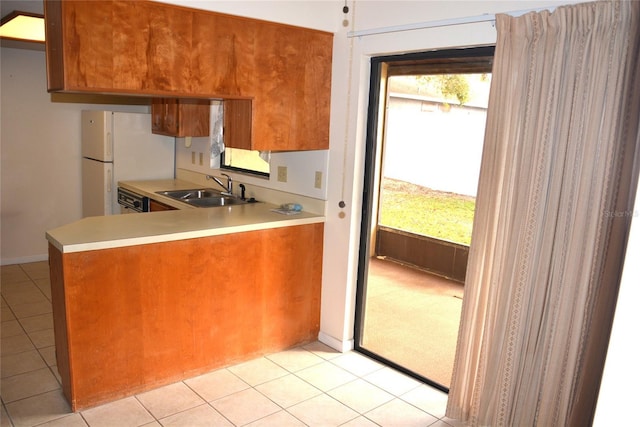 17 Kendra Ct, Winter Haven, FL 33880 - kitchen featuring light tile patterned flooring, a healthy amount of sunlight, sink, and white fridge