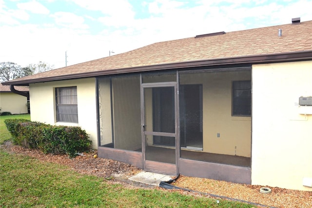 17 Kendra Ct, Winter Haven, FL 33880 - back of property featuring a sunroom and a lawn