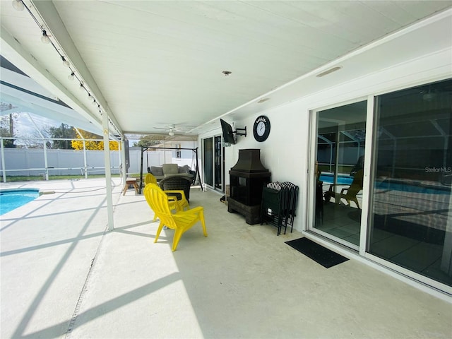 view of patio / terrace with a fenced in pool, an outdoor living space, and ceiling fan