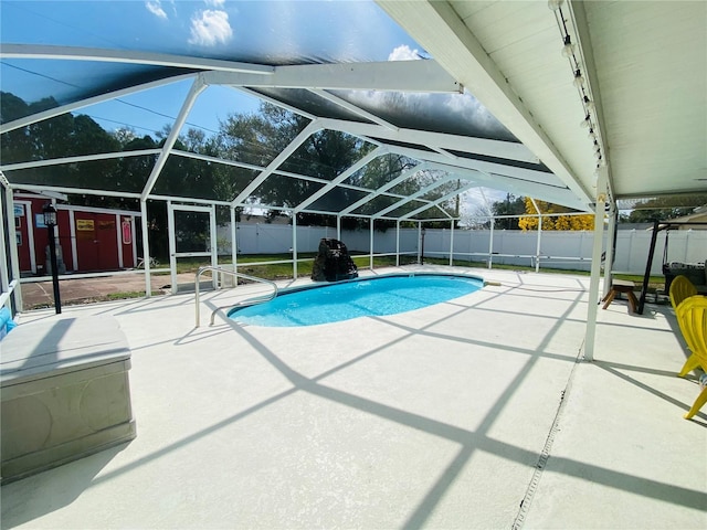 view of swimming pool featuring a lanai and a patio