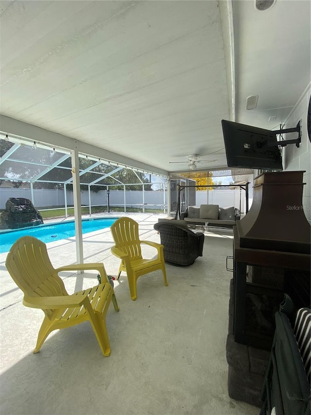 exterior space featuring an outdoor living space, glass enclosure, and a patio area