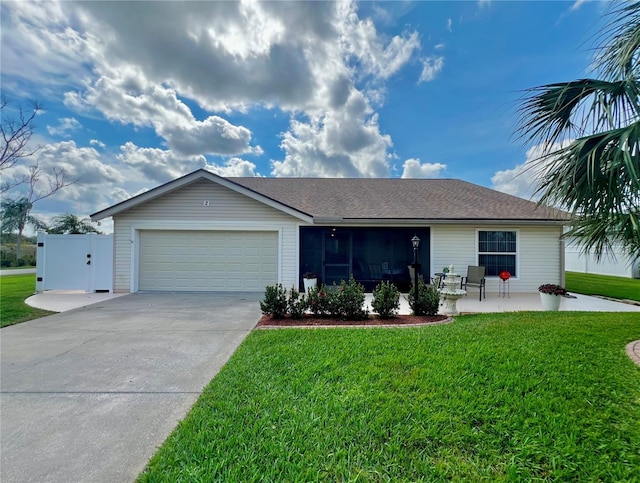 ranch-style home featuring a garage, driveway, a shingled roof, a patio, and a front yard