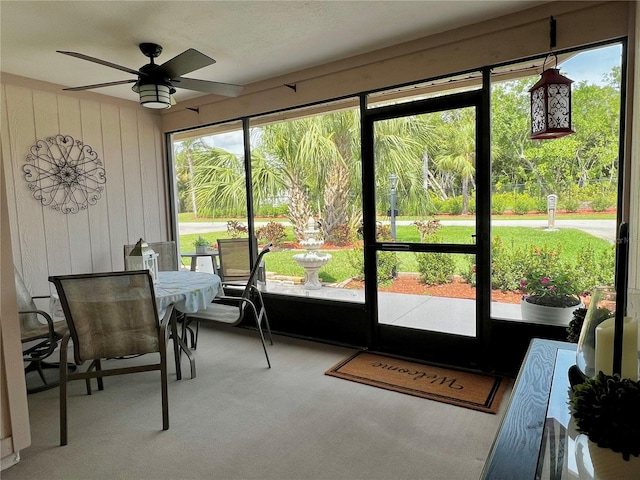 sunroom / solarium with a ceiling fan