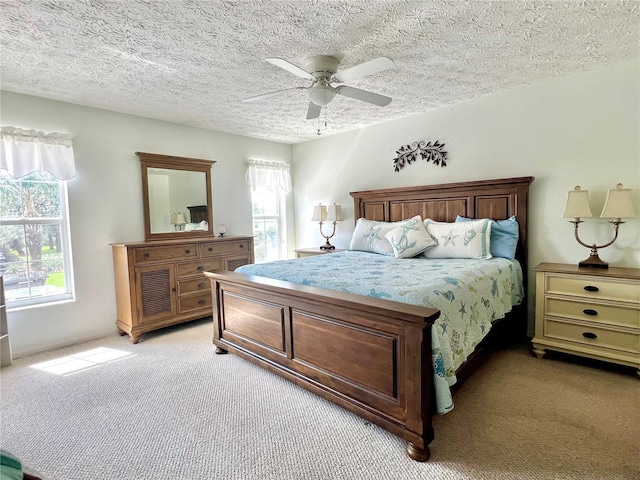bedroom with ceiling fan, multiple windows, and light colored carpet
