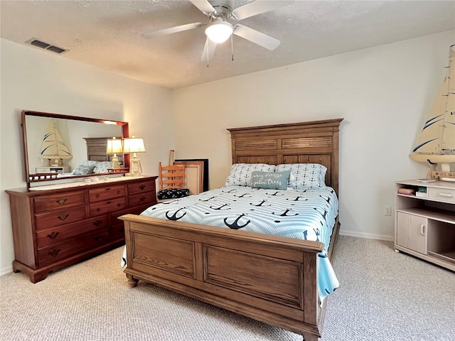 bedroom featuring visible vents, a ceiling fan, light carpet, a textured ceiling, and baseboards