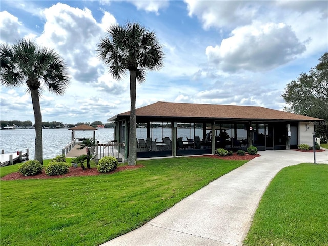 view of home's community featuring a water view and a yard