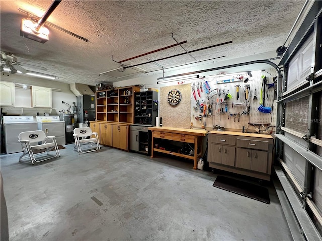 garage with a workshop area and washing machine and dryer