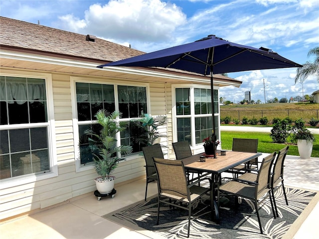view of patio / terrace featuring fence and outdoor dining area