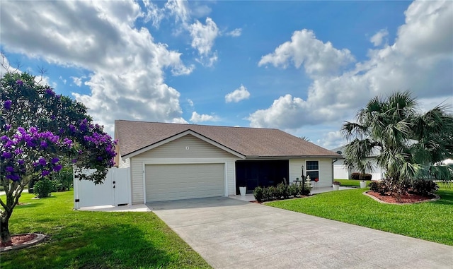 ranch-style house with a garage, concrete driveway, and a front yard