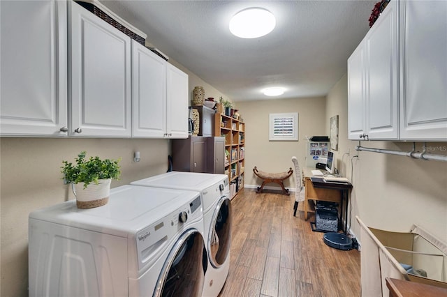 laundry room featuring independent washer and dryer, wood finished floors, cabinet space, and baseboards