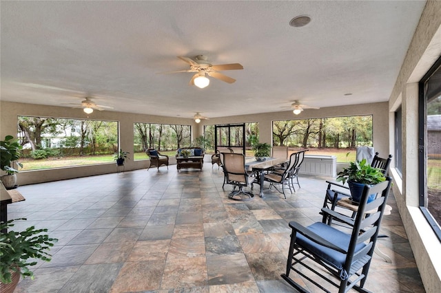 view of patio featuring ceiling fan, outdoor dining space, and an outdoor hangout area