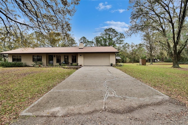 ranch-style home featuring concrete driveway, a front lawn, a chimney, and an attached garage