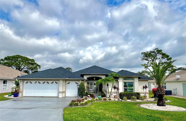 ranch-style home with an attached garage, driveway, a front yard, and stucco siding