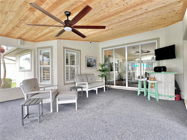 sunroom featuring wooden ceiling and ceiling fan