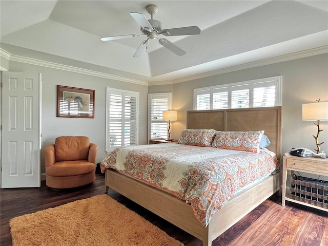 bedroom featuring a tray ceiling, wood finished floors, and ornamental molding