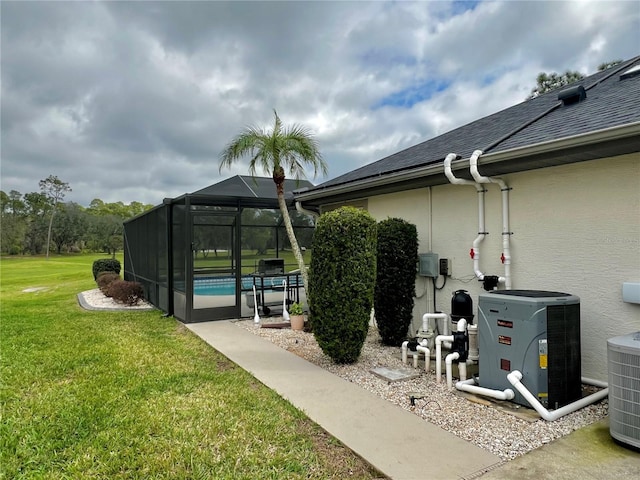 view of yard featuring a lanai, central air condition unit, and an outdoor pool