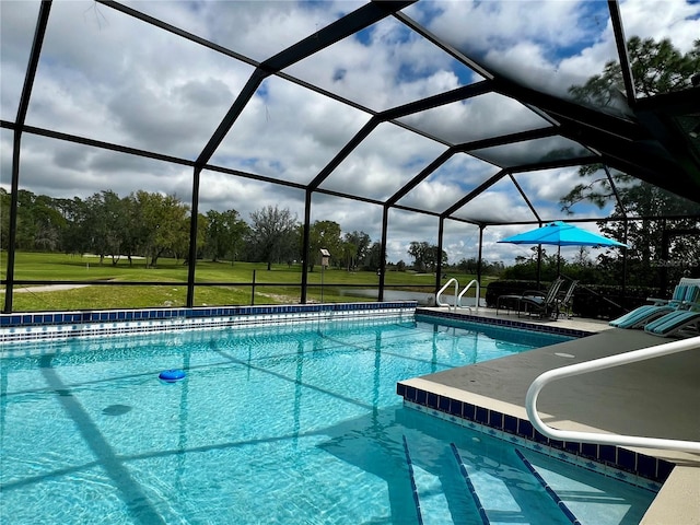 pool featuring a lanai, a patio area, and a yard