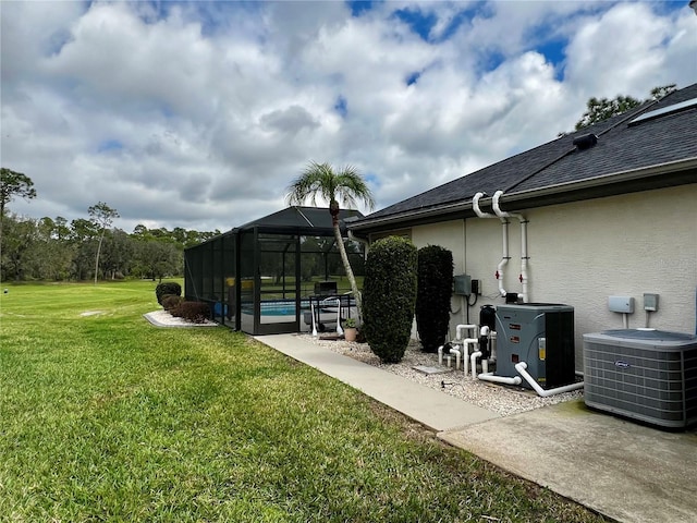 view of yard with a lanai, a pool, and central AC