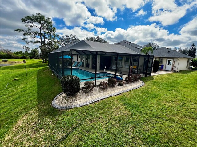 rear view of property with a yard, glass enclosure, an outdoor pool, and a patio