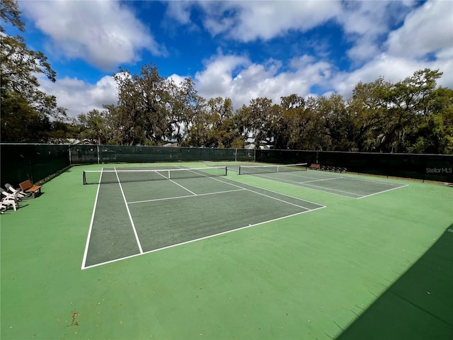 view of tennis court with fence