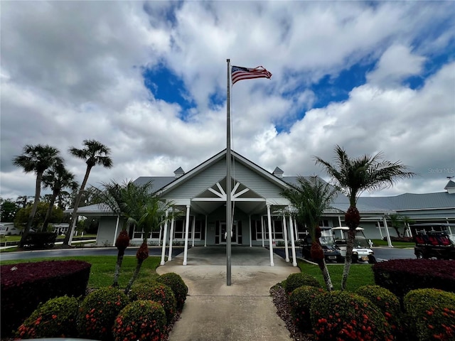 view of building exterior with a carport and concrete driveway