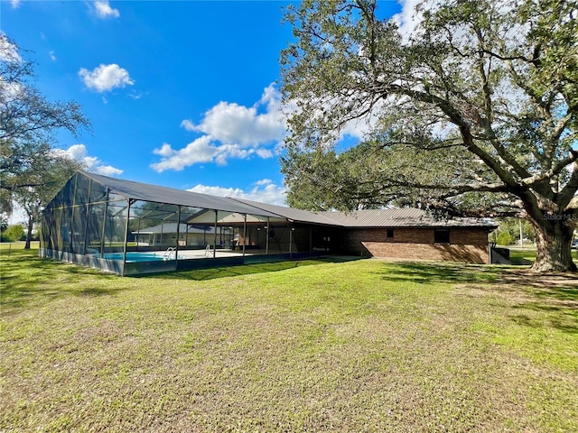 view of yard featuring a lanai and an outdoor pool