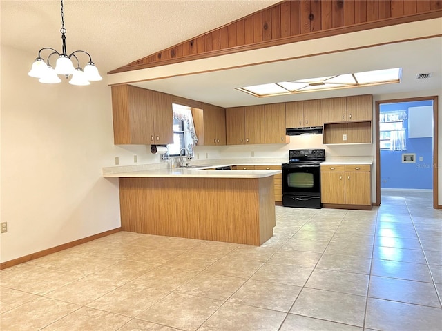 kitchen with electric range, visible vents, a peninsula, vaulted ceiling, and light countertops