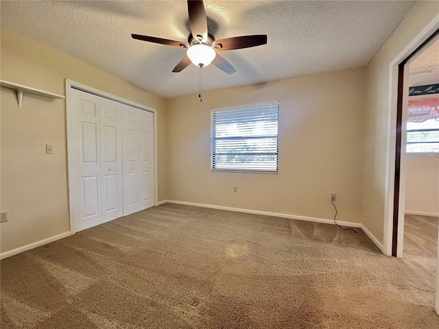 unfurnished bedroom featuring a closet, carpet flooring, baseboards, and multiple windows