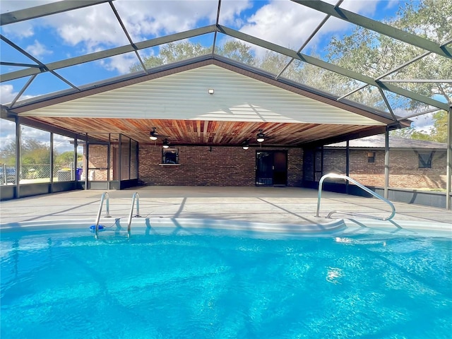 pool with a lanai, ceiling fan, and a patio