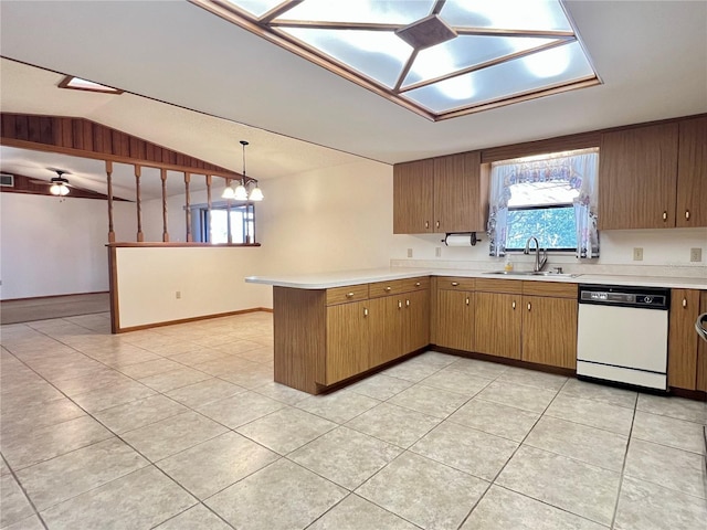 kitchen with light countertops, vaulted ceiling, white dishwasher, a sink, and a peninsula