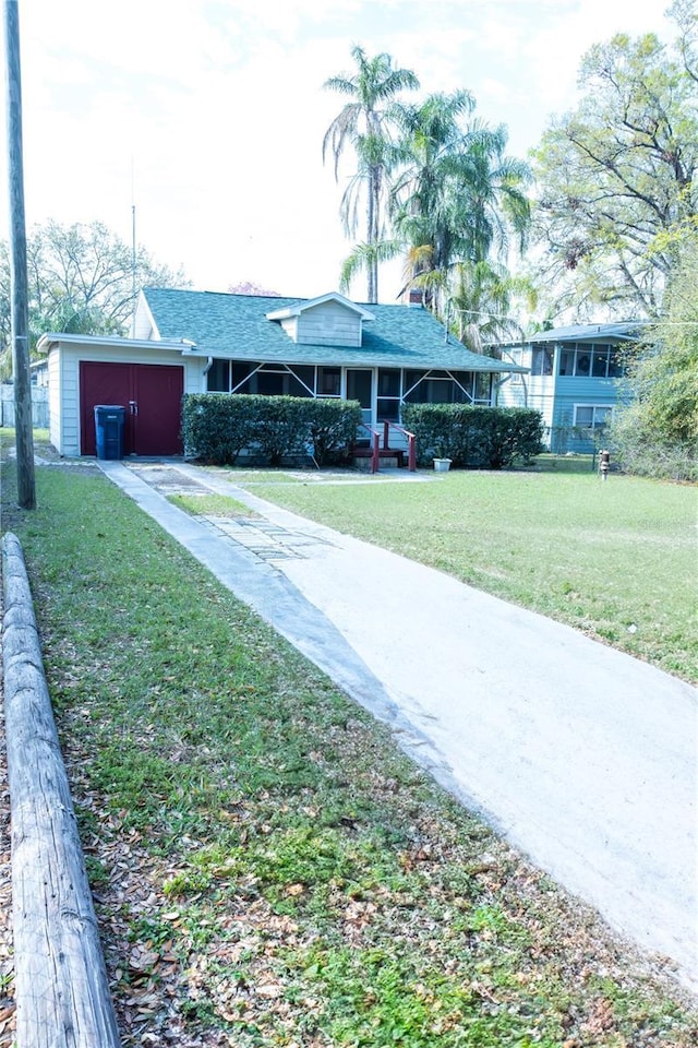 view of front of house featuring concrete driveway and a front yard