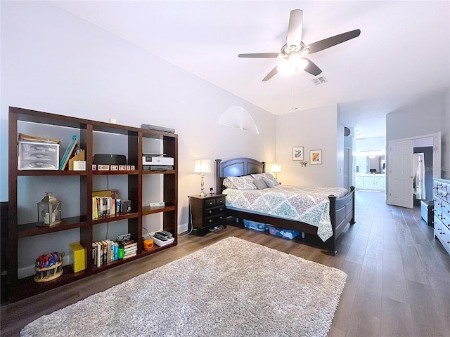 bedroom with a ceiling fan, wood finished floors, fridge, and visible vents