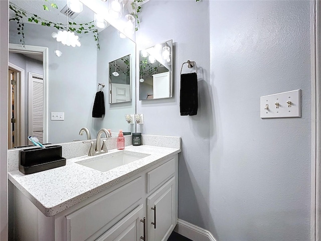 bathroom with vanity and baseboards