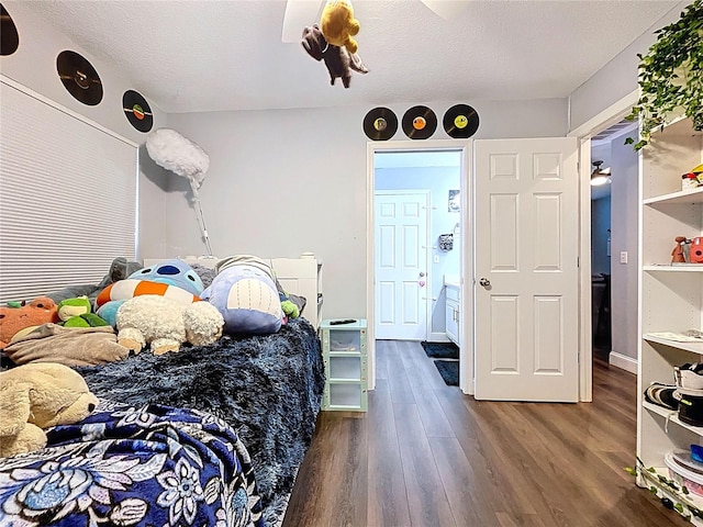 bedroom with wood finished floors and a textured ceiling