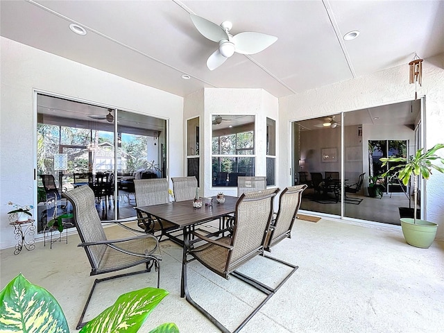 sunroom featuring a ceiling fan and outdoor dining area