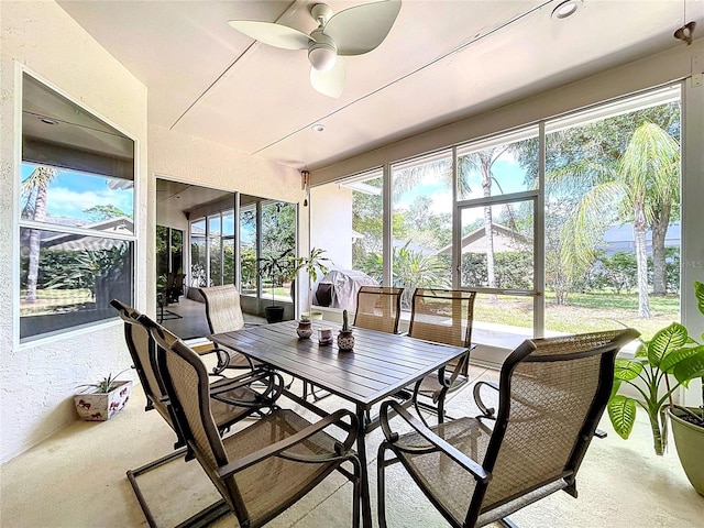 sunroom / solarium with a wealth of natural light, outdoor dining area, and ceiling fan