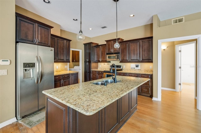 6928 Hayter Ln, Lakeland, FL 33813 - kitchen featuring a sink, dark brown cabinetry, baseboards, appliances with stainless steel finishes, and visible vents