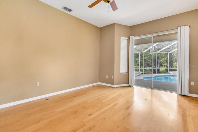 6928 Hayter Ln, Lakeland, FL 33813 - spare room featuring a ceiling fan, light wood finished floors, baseboards, a sunroom, and visible vents