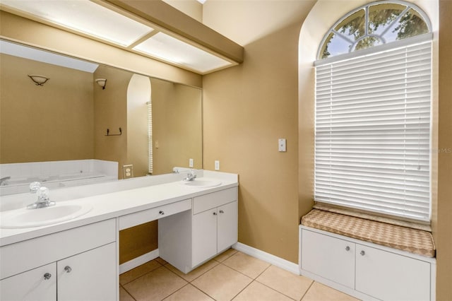 6928 Hayter Ln, Lakeland, FL 33813 - bathroom featuring double vanity, tile patterned flooring, baseboards, and a sink