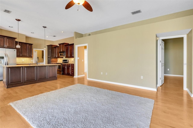 6928 Hayter Ln, Lakeland, FL 33813 - kitchen featuring stainless steel appliances, a ceiling fan, visible vents, and light countertops