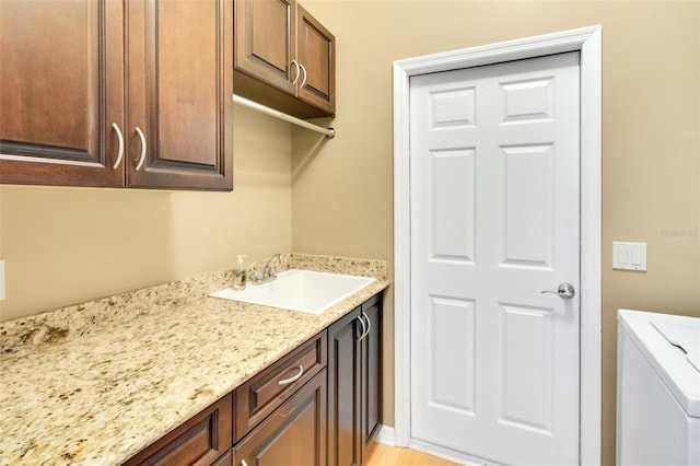 6928 Hayter Ln, Lakeland, FL 33813 - laundry area featuring cabinet space, washer / clothes dryer, and a sink