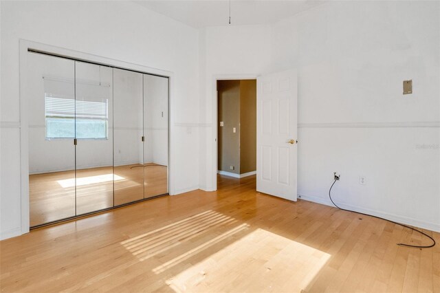 6928 Hayter Ln, Lakeland, FL 33813 - unfurnished bedroom featuring baseboards, wood finished floors, and a closet