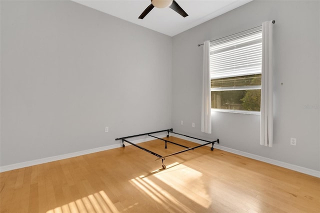 6928 Hayter Ln, Lakeland, FL 33813 - empty room with wood finished floors, baseboards, and ceiling fan
