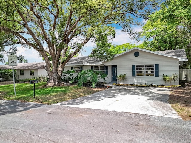 ranch-style home featuring a front yard and driveway