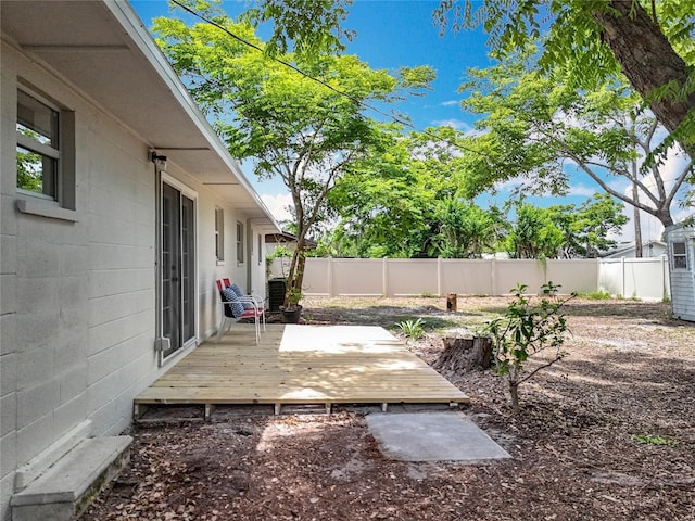 fenced backyard with a deck