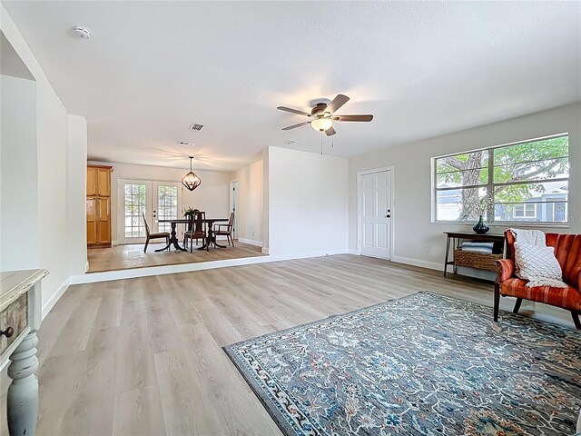 entrance foyer with light wood-style floors, baseboards, and ceiling fan
